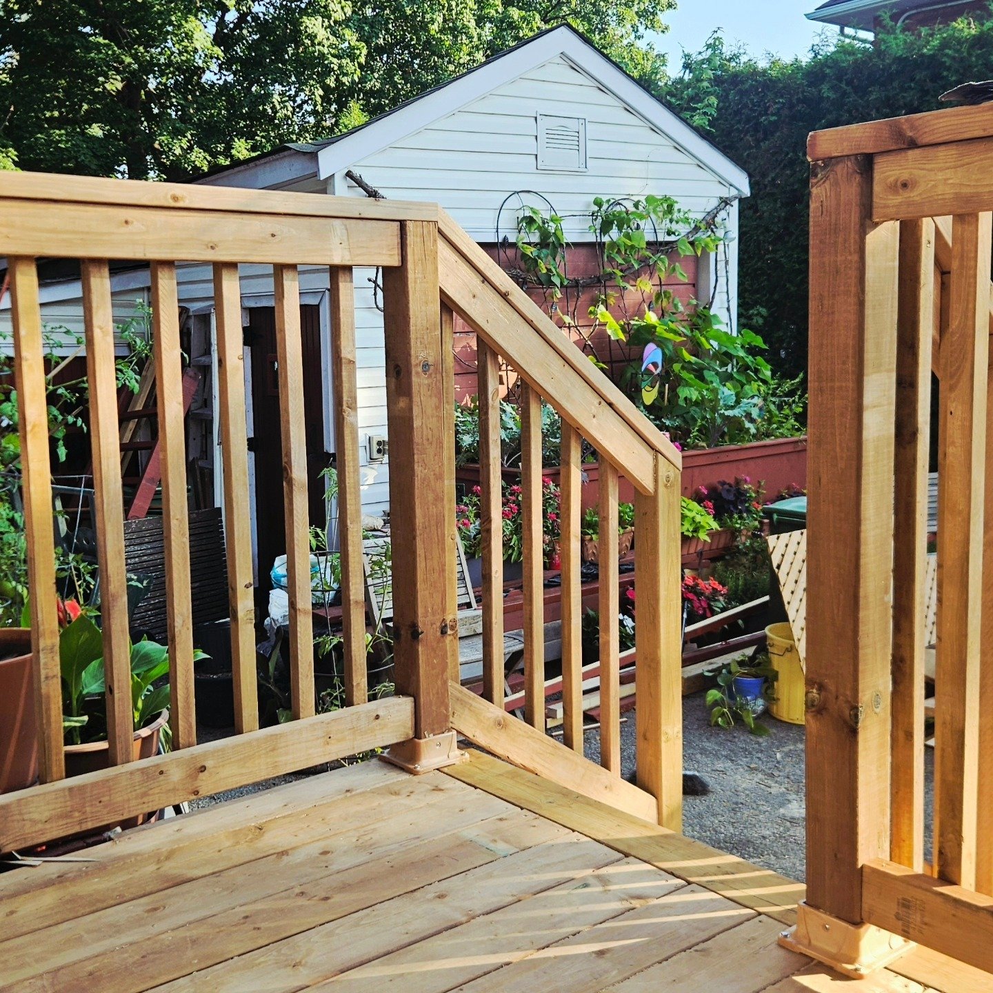 Deck railing and stairs in a backyard garden
